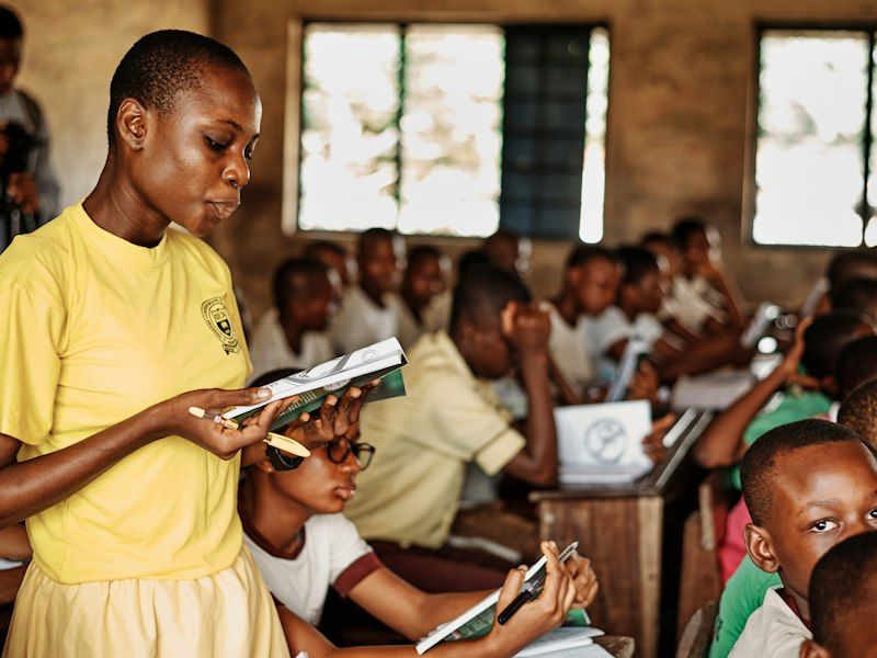 Teacher standing before children in a classroom